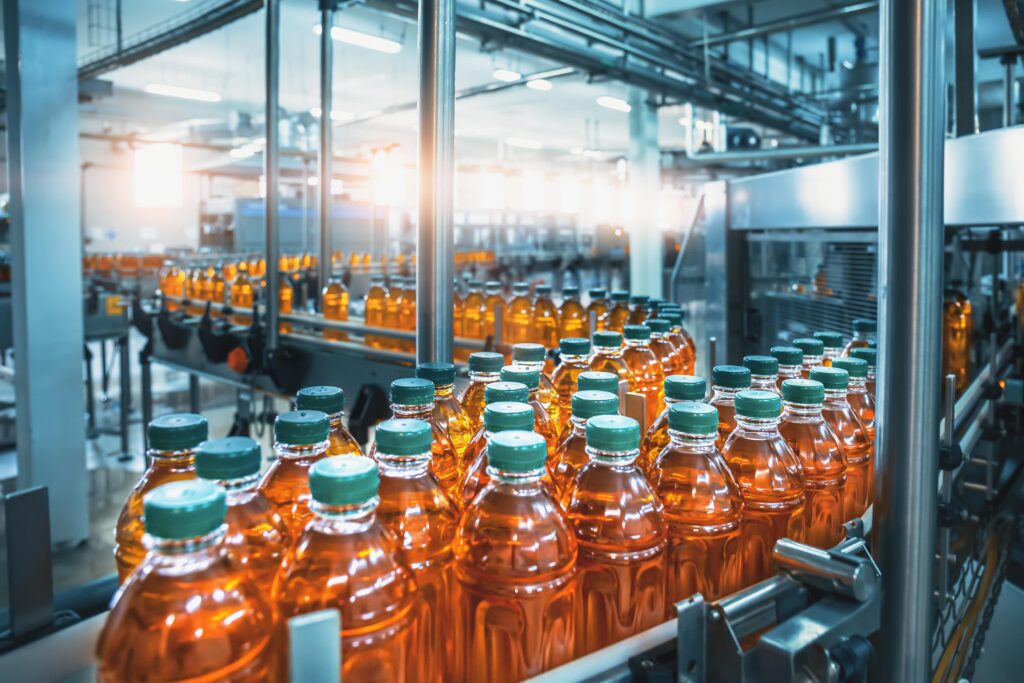 Conveyor belt moving bottles in a food and beverage plant.