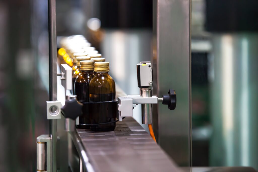 Bottles going through a conveyor belt system.