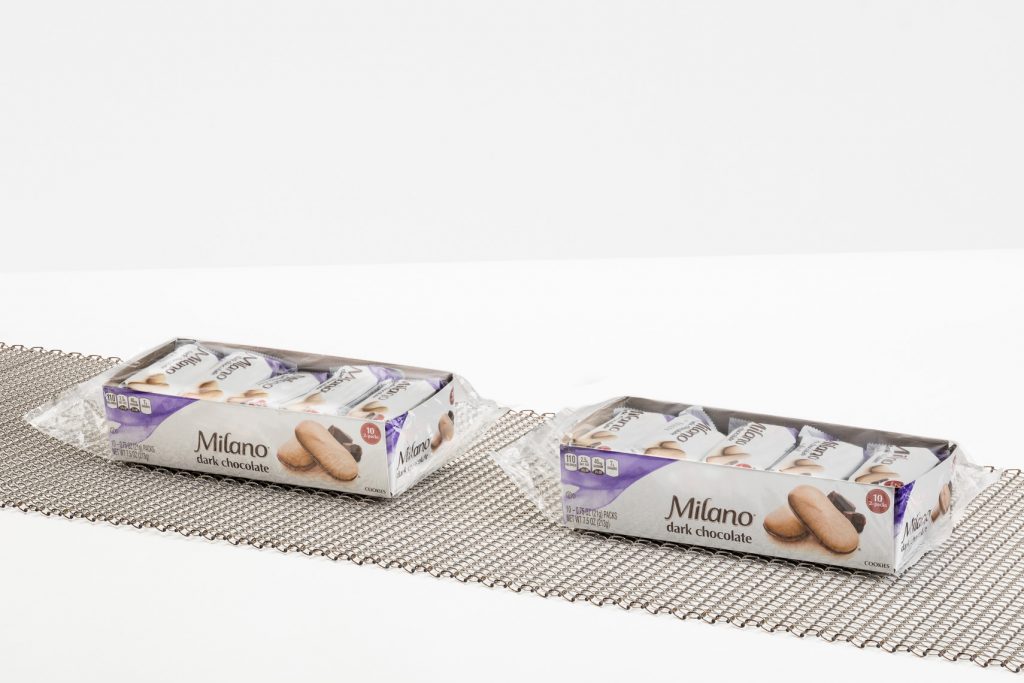 Belt in life environment with product ontop A balanced weave conveyor belt transporting Milano cookies.